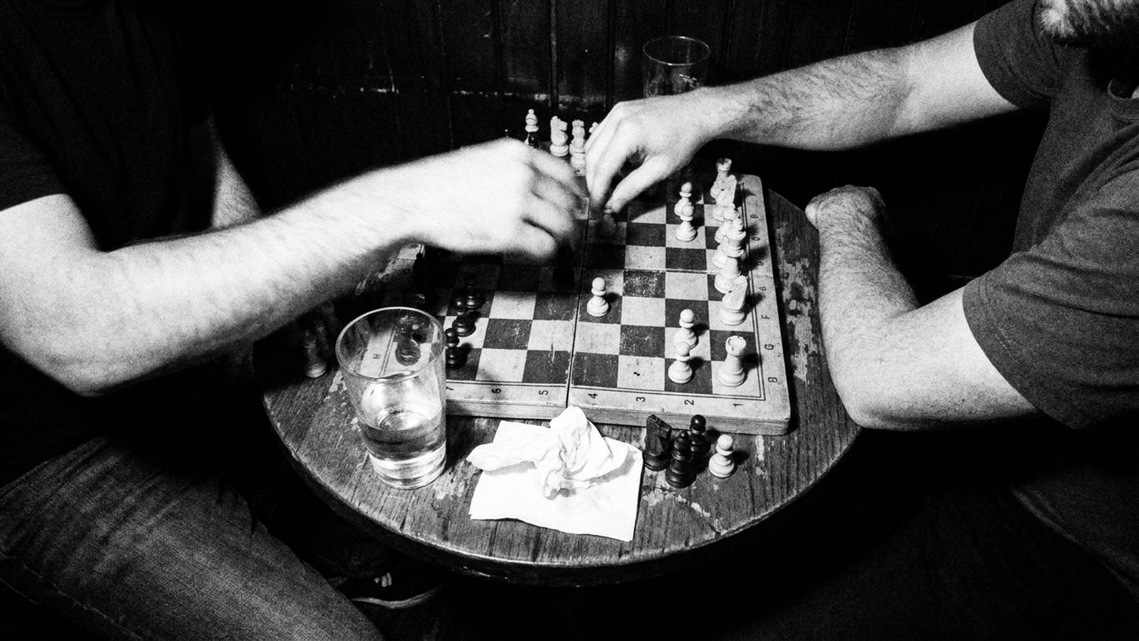 Two players over a chessboard late at night